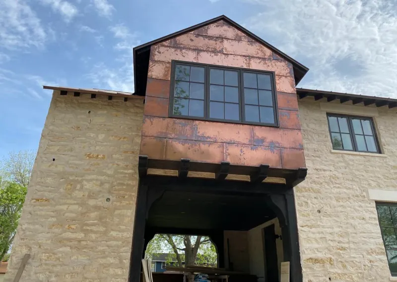 Copper metal panel facade on a stone building for Skylight Installation in Waikele
